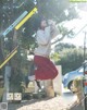 A woman jumping in the air in front of a bike.